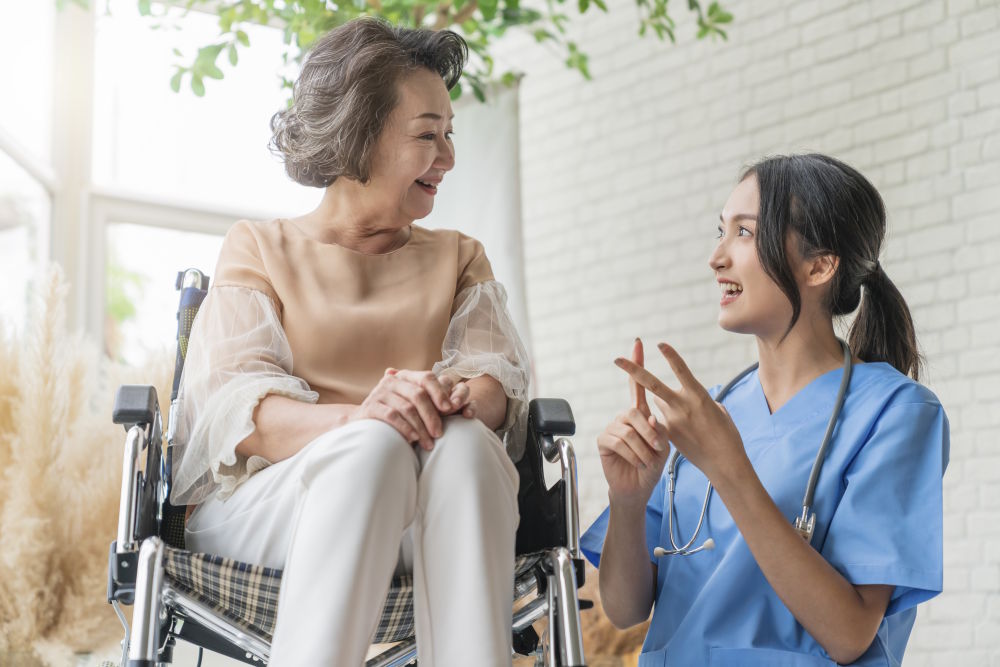 Caregiver assisting patient in wheelchair